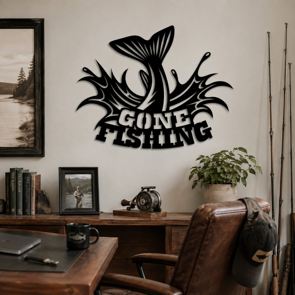 A black metal wall art piece featuring a jumping fish and the words 'GONE FISHING' mounted on a beige wall in a home office setting with a desk, chair, and framed photos.
