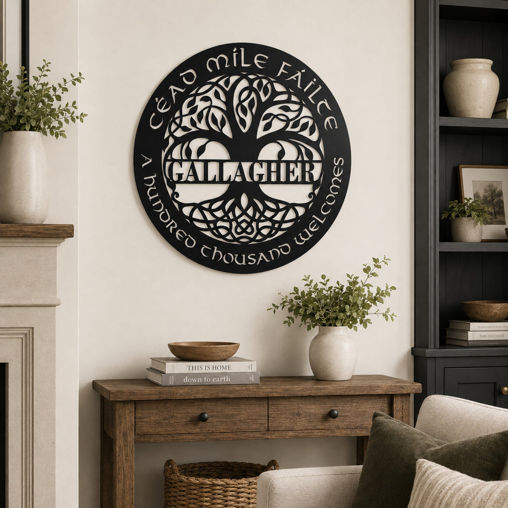 A circular black metal wall sign featuring a tree of life and the text 'Cead mile Fáilte / A hundred thousand welcomes / Callachan', displayed on a cream wall above a rustic wooden console table in a styled living room.