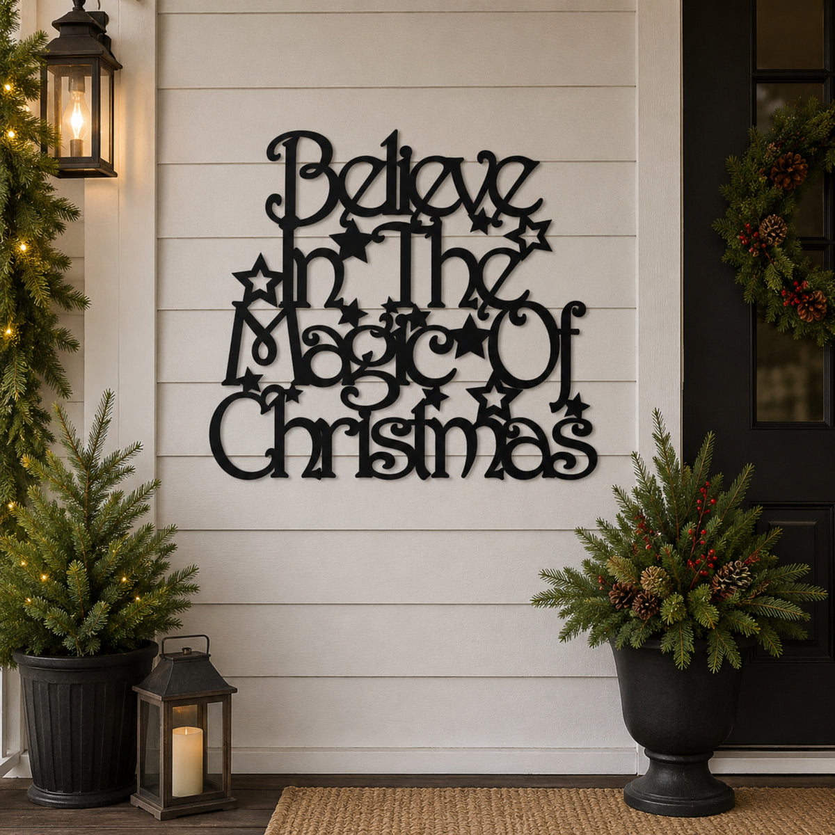Black metal wall art reading 'Believe in the Magic of Christmas' with star accents, displayed on a white shiplap wall in a decorated holiday front porch setting with potted plants and lanterns.