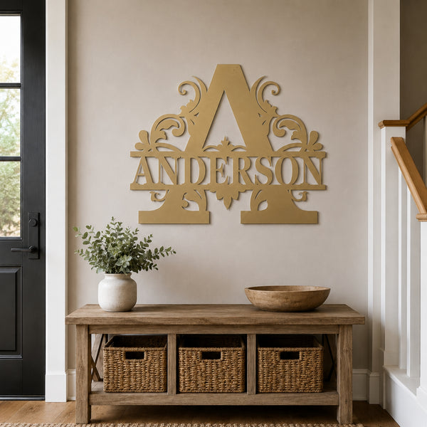 A large decorative wooden letter A with the name ANDERSON cut through it is mounted on a beige wall above a rustic wood console table with woven baskets, a vase of greenery, and a wooden bowl.