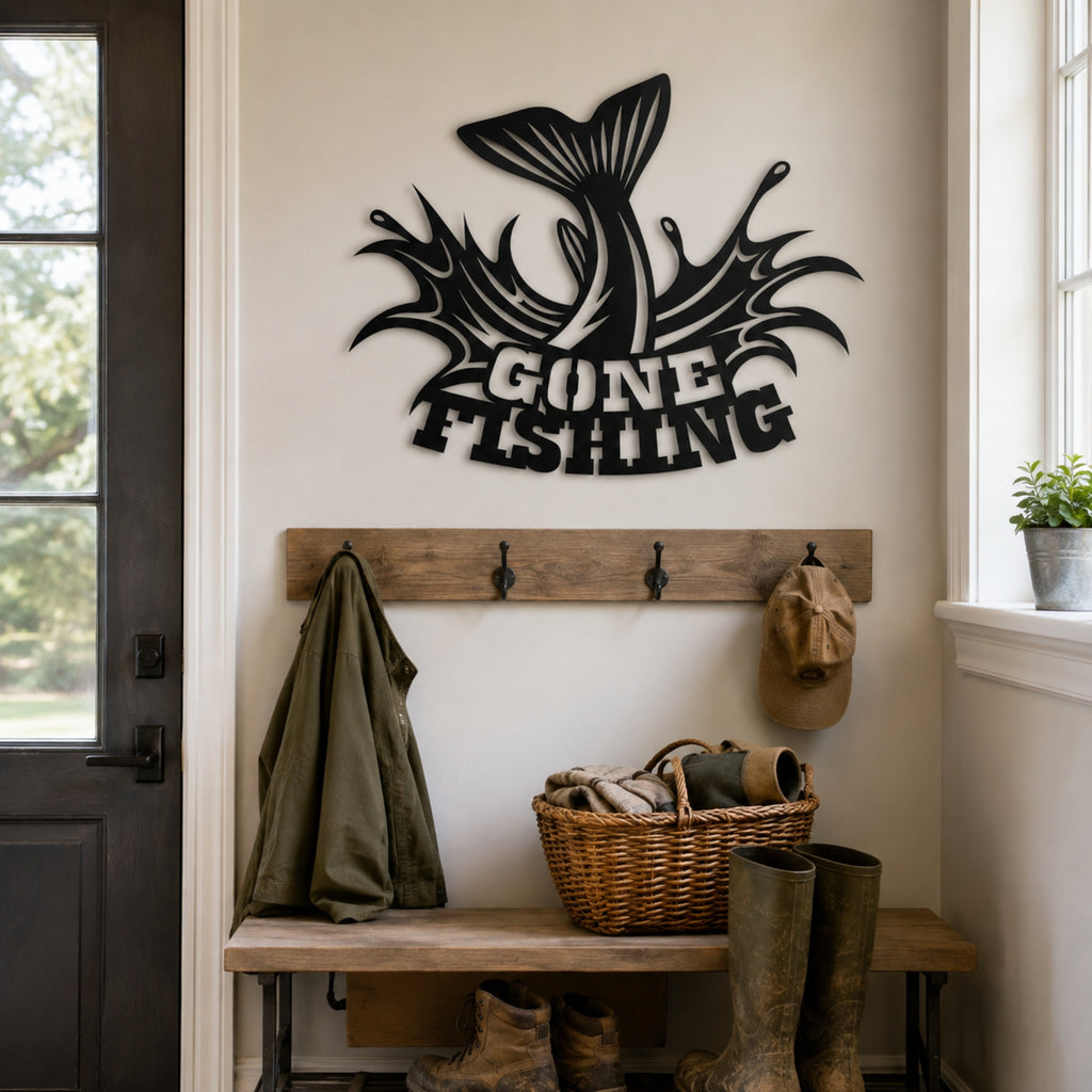 A black metal wall sign reading 'GONE FISHING' with a fish tail graphic, mounted on a beige wall above a rustic wooden entryway bench with hooks, a green jacket, a wicker basket, and rubber boots.