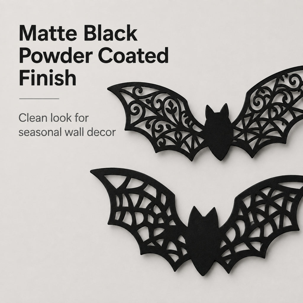 Two black bat-shaped wall decorations with intricate cutout wing patterns, shown on a light gray background with text describing a matte black powder-coated finish.