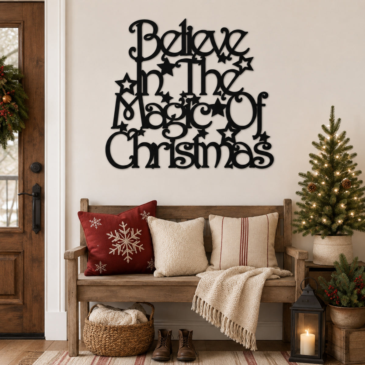 Black metal wall art reading 'Believe in the Magic of Christmas' displayed above a wooden bench in a decorated holiday living room setting.