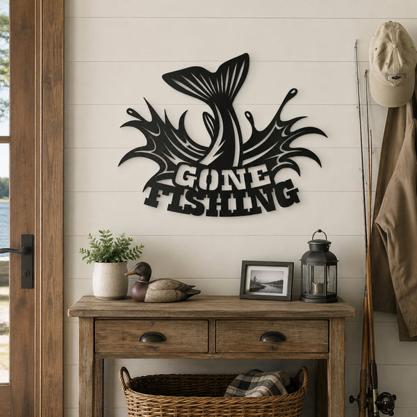 Black metal wall art featuring a jumping fish tail and the words 'GONE FISHING' in a rustic cabin-style room above a wooden console table.