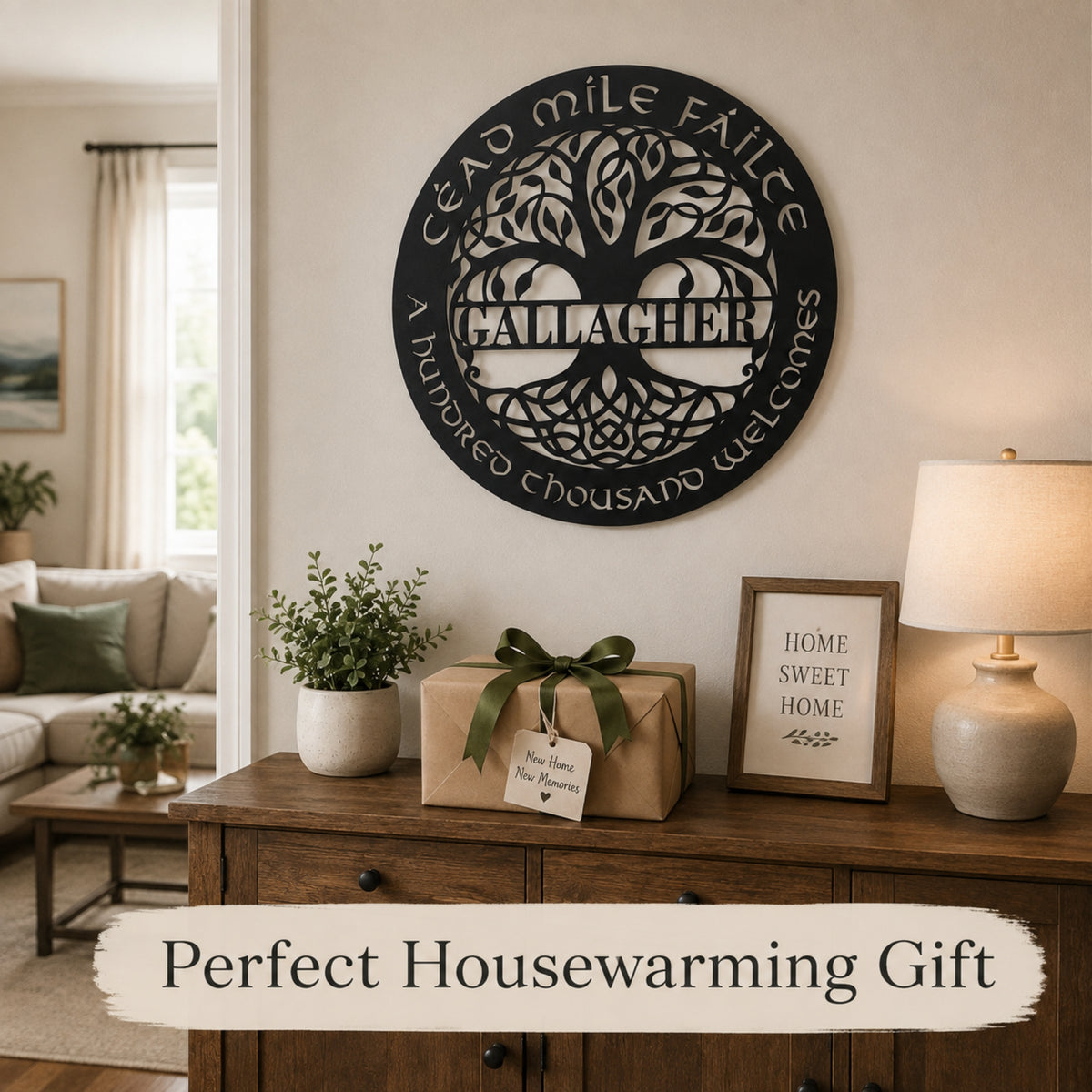 A round black metal wall sign with a tree of life design and the text 'Cord Mille Faealte / Calaver' displayed on a beige wall above a wooden console table. The scene includes a wrapped gift box, a framed sign, and a lamp, with a banner at the bottom reading 'Perfect Housewarming Gift'.