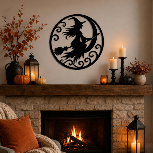 A black metal witch silhouette on a crescent moon wall decor piece is displayed above a stone fireplace mantel decorated with candles, pumpkins, and autumn foliage.